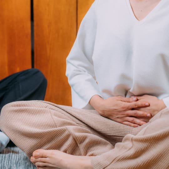 A person in a relaxed posture practicing meditation and breathwork for inner peace and wellness.