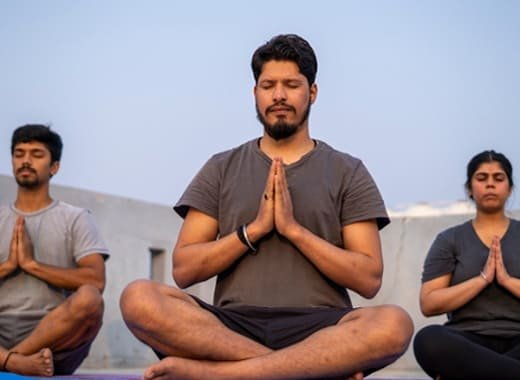 practicing meditation outdoors in a peaceful setting